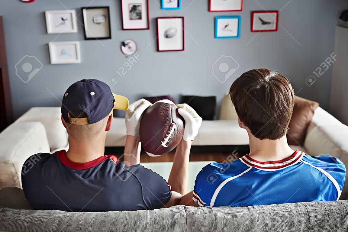 Three men with American football equipment