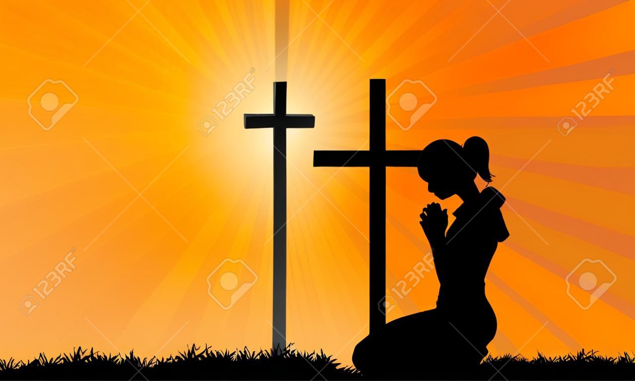 Silhouette of a woman praying under the cross