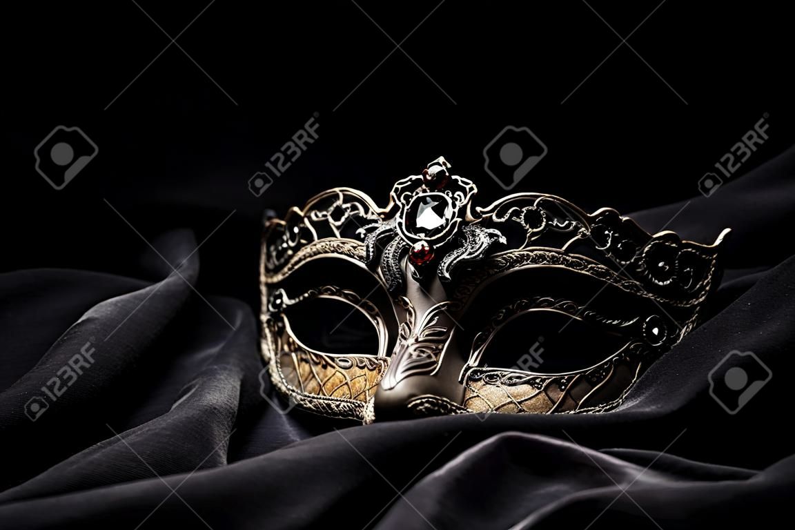 Brown carnival mask on black background