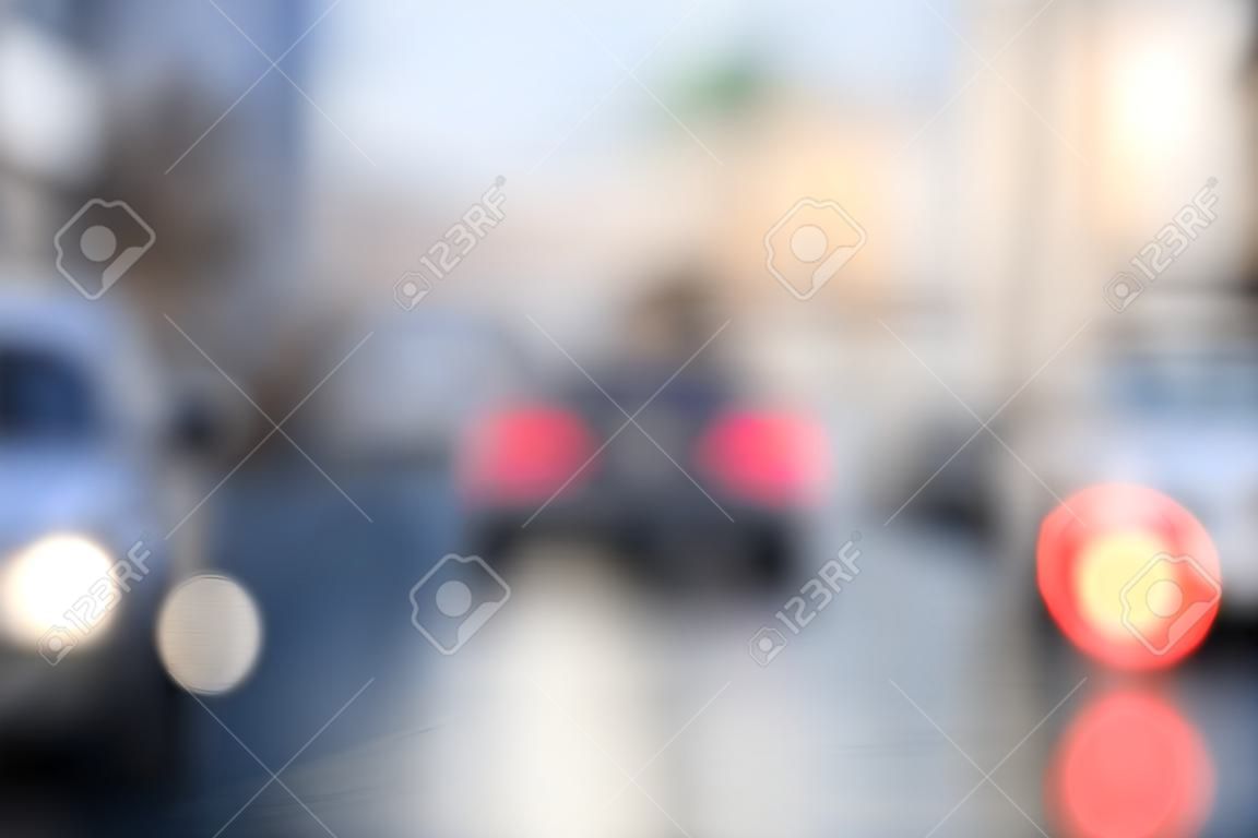 Traffic abstract background with blurry buildings, street signs and cars