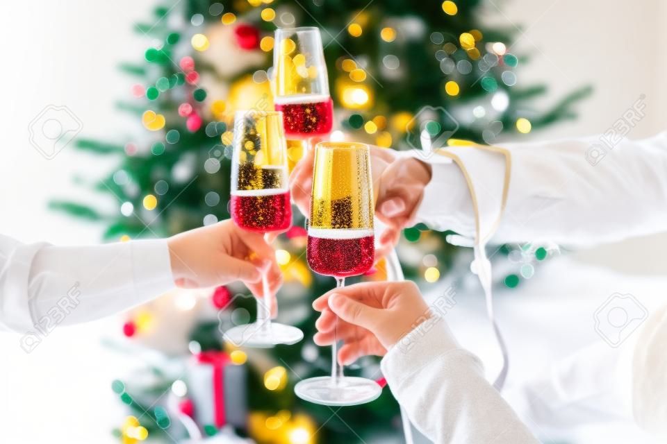 New year and Christmas celebration with champagne in front the Christmas tree.