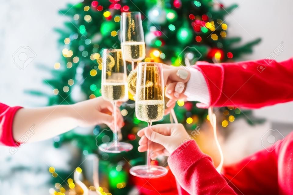 New year and Christmas celebration with champagne in front the Christmas tree.