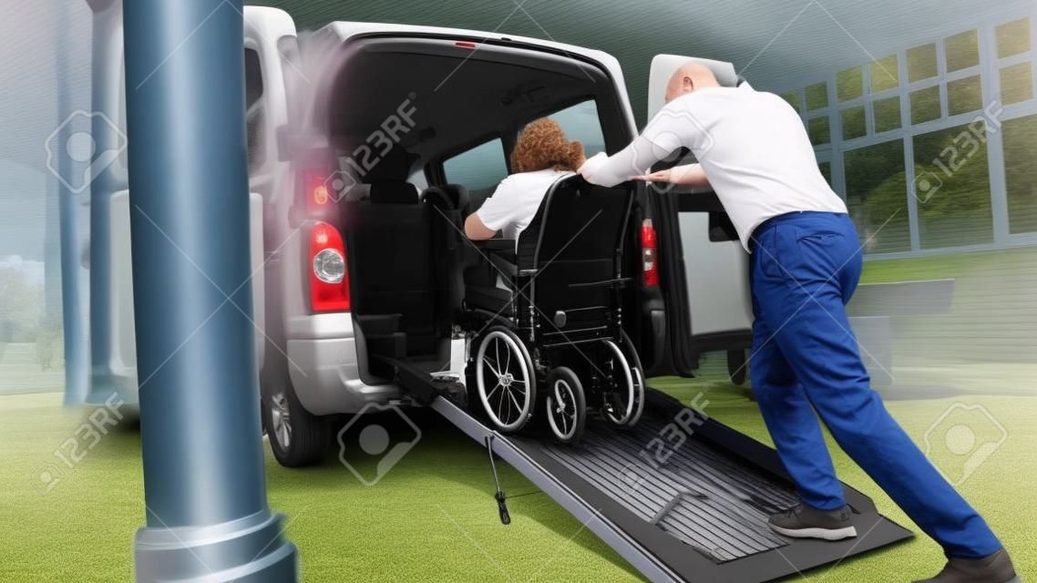 Wheelchair user leaving vehicle adapted for disabled transport with ramp and lift.
