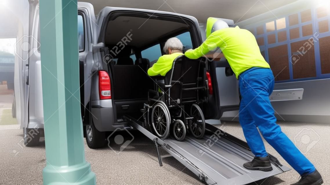 Wheelchair user leaving vehicle adapted for disabled transport with ramp and lift.