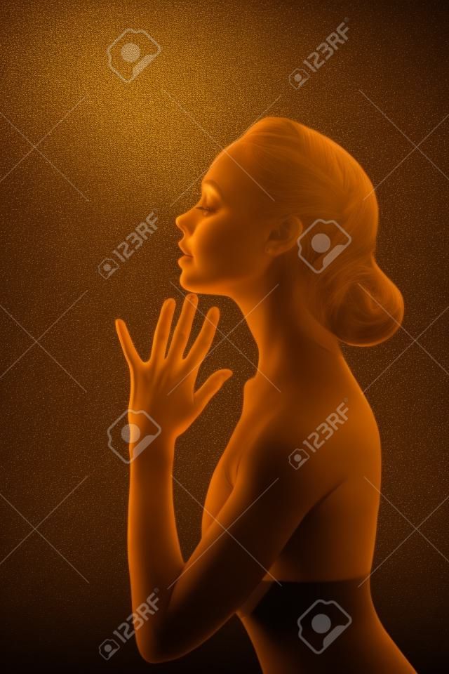 Woman with Golden Body over Black Background