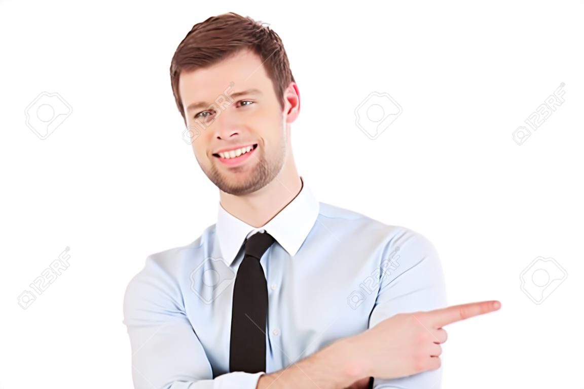 Businessman pointing copy space. Handsome young man in shirt and tie looking at camera and pointing away while standing isolated on white background