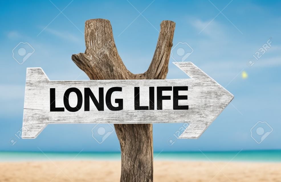 Long life sign with arrow on beach background