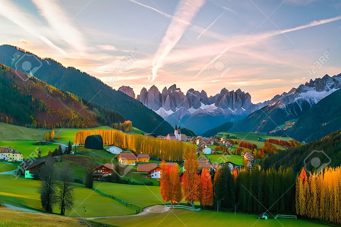 Colorful autumn scenery in Santa Maddalena village with mountain peaks on background at sunrise. Dolomite Alps, South Tyrol, Italy.