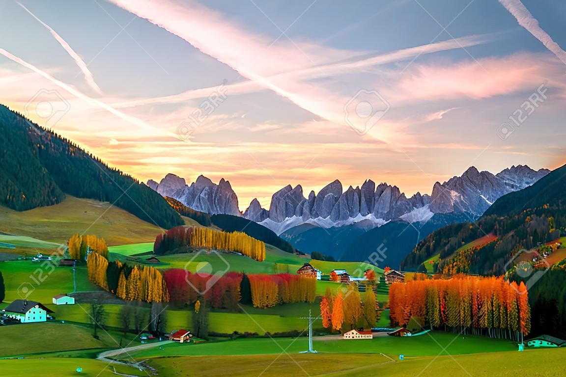 Colorful autumn scenery in Santa Maddalena village with mountain peaks on background at sunrise. Dolomite Alps, South Tyrol, Italy.