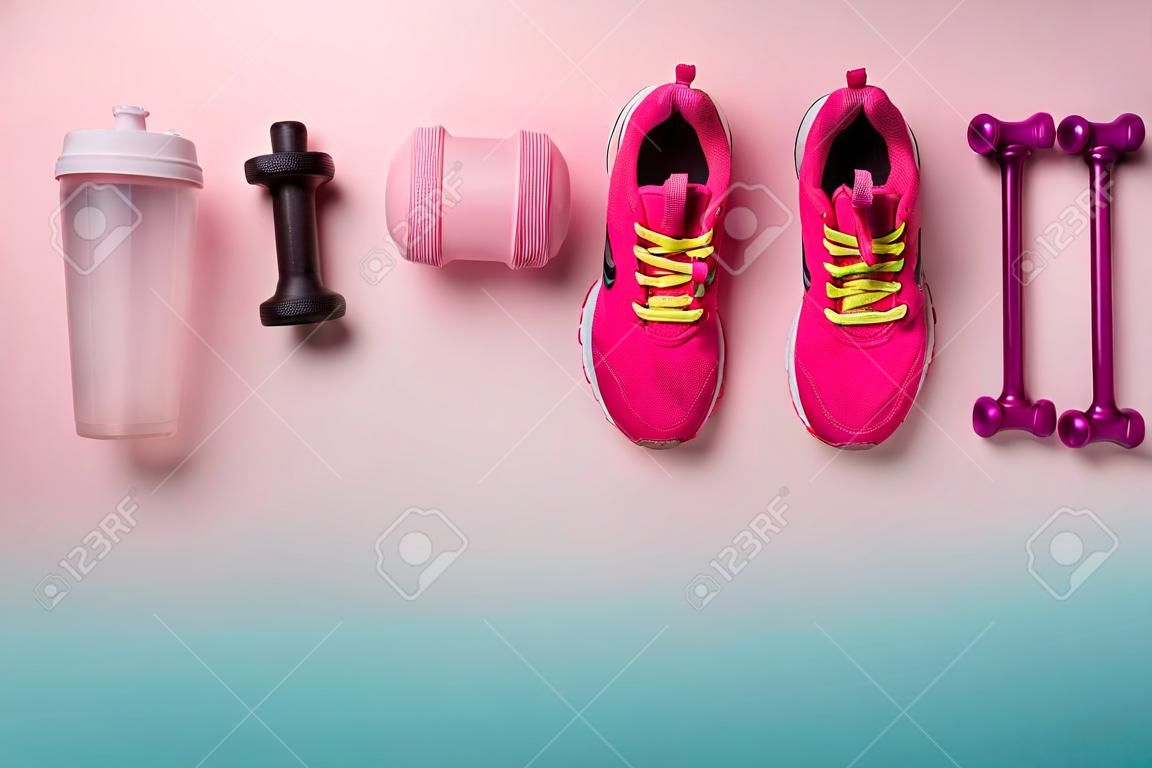 A studio shot of running shoes and other sport equipment on color background.