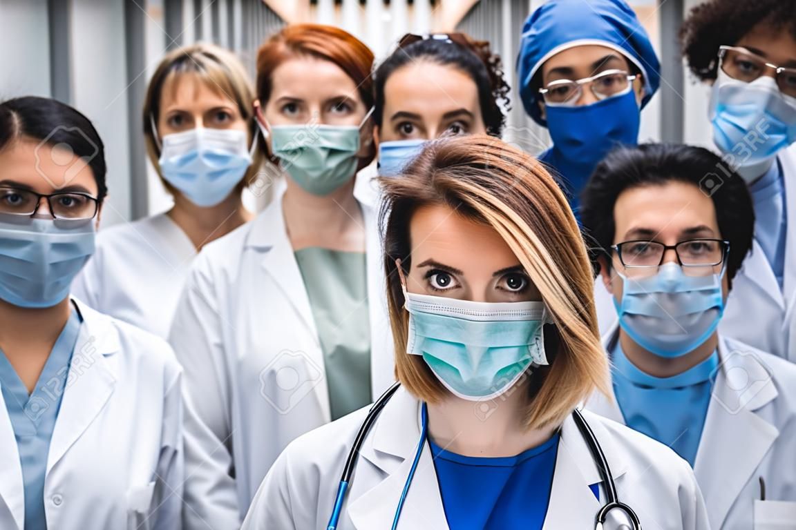 Grupa lekarzy z maskami na twarz patrząc na kamerę, koncepcja wirusa korony.