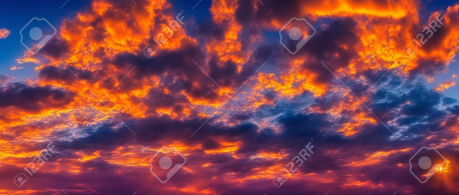 Panorama of gorgeous sun is shining in the twilight sky and colorful clouds, Beautiful nature scene