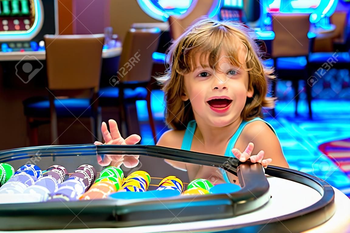 Happy Boy In The Casino. Gambling. Entertainment And Leisure. Casino Chips.  Child. Фотография, картинки, изображения и сток-фотография без роялти.  Image 152313219