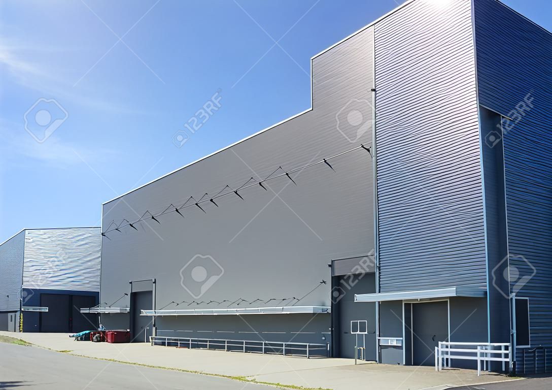 exterior of a modern warehouse building against a blue sky