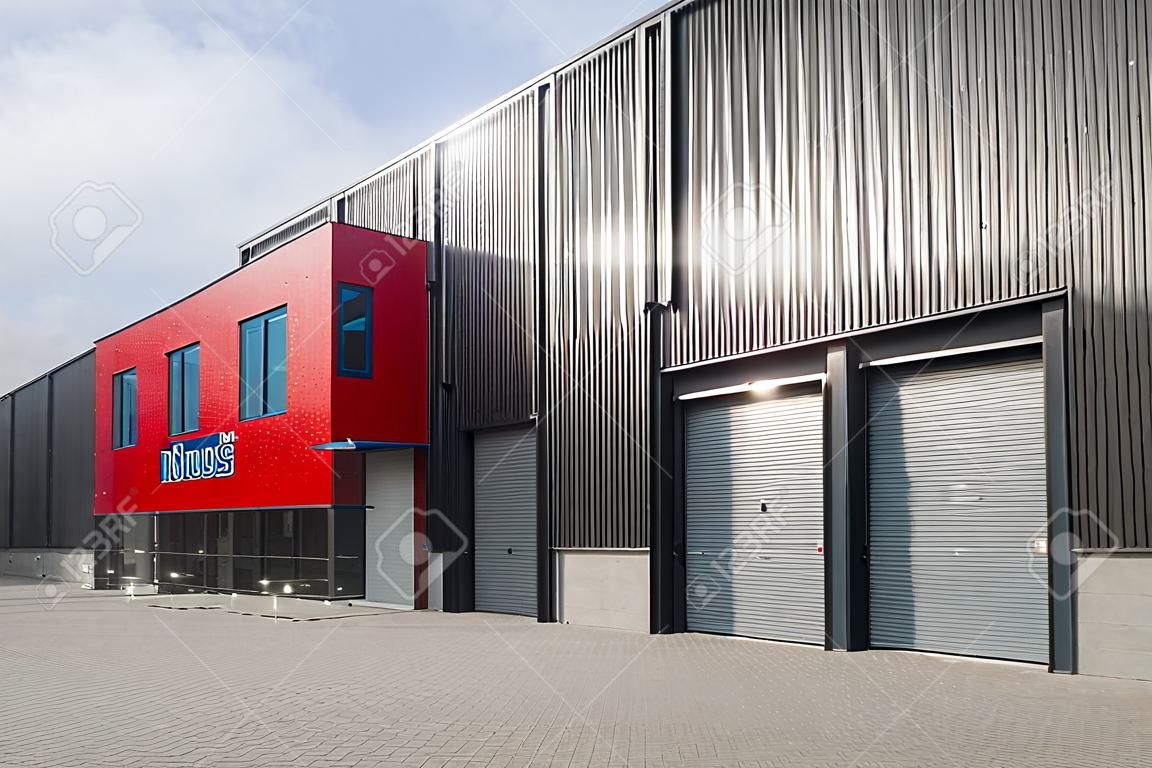 newly build red industrial warehouse with offices