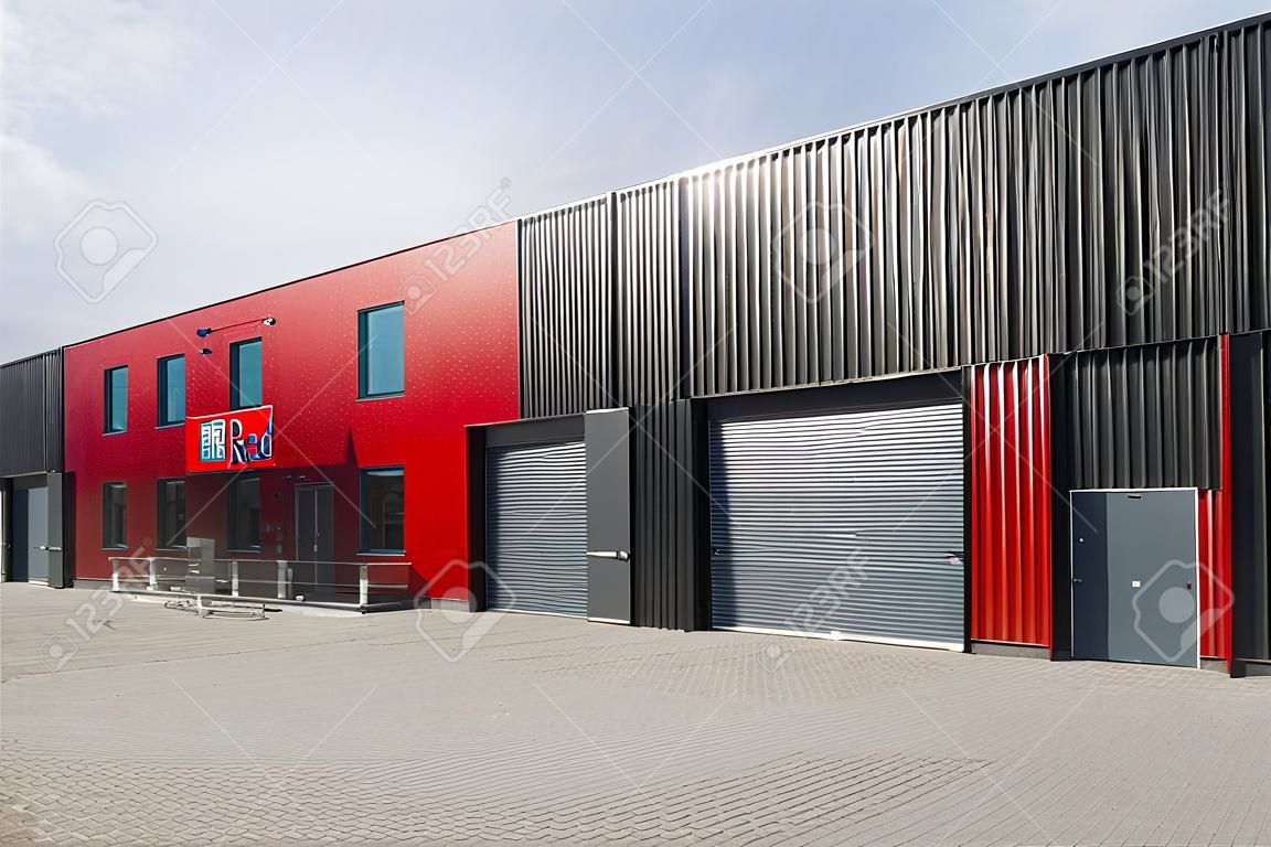 newly build red industrial warehouse with offices