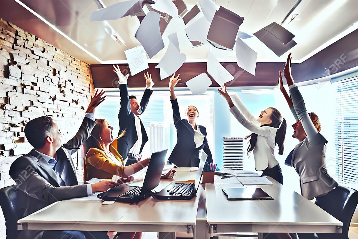Teamwork business people excited happy smile, throw papers and documents fly in air. Success team concept after sign contract