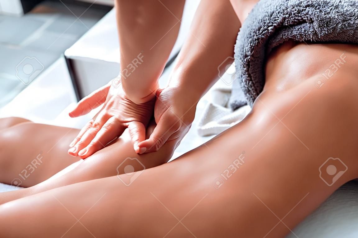 Woman enjoying during a back massage at the spa. Close up view