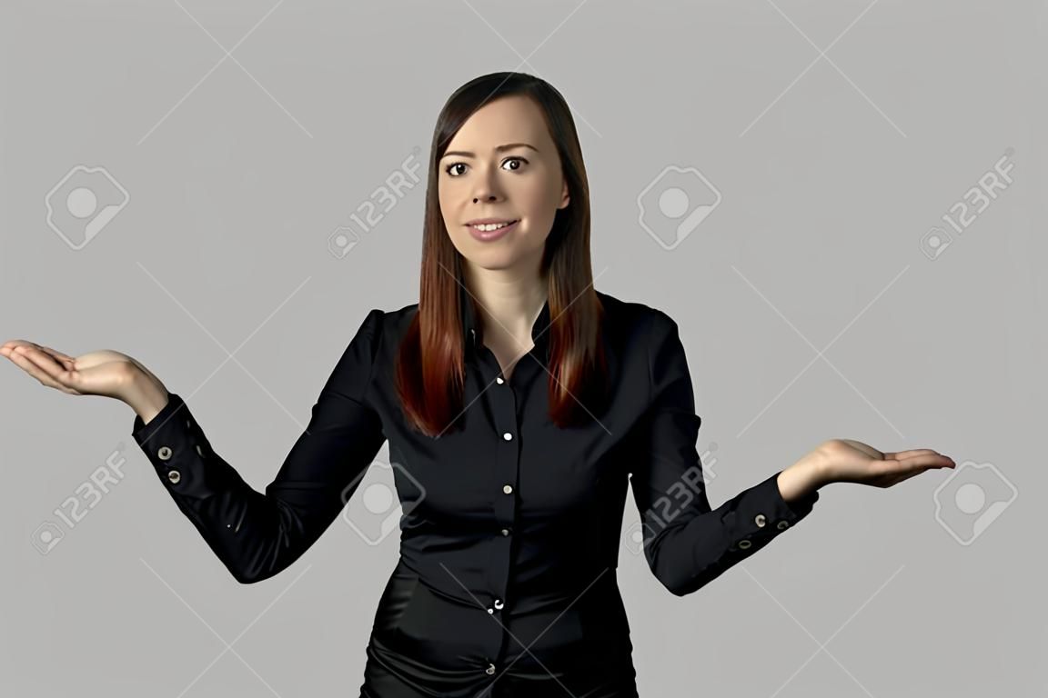 smiling woman on a white background holds her palms like a bowls of scales, as if weighing the pros and cons