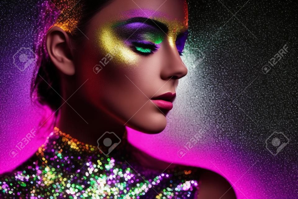 Portrait of beautiful woman with sparkles on her face. Girl with art make up in color light. Fashion model with colorful make-up. Black and White