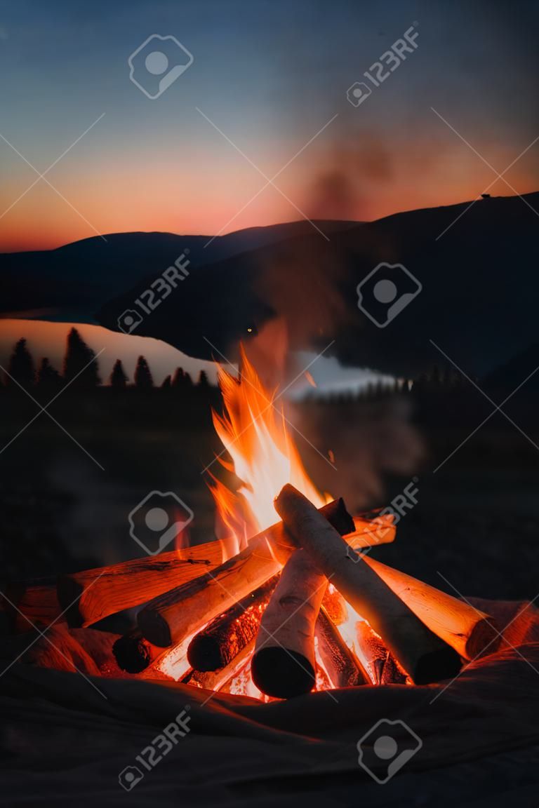 Bonfire on the background of the mountains at sunset. Camping concept