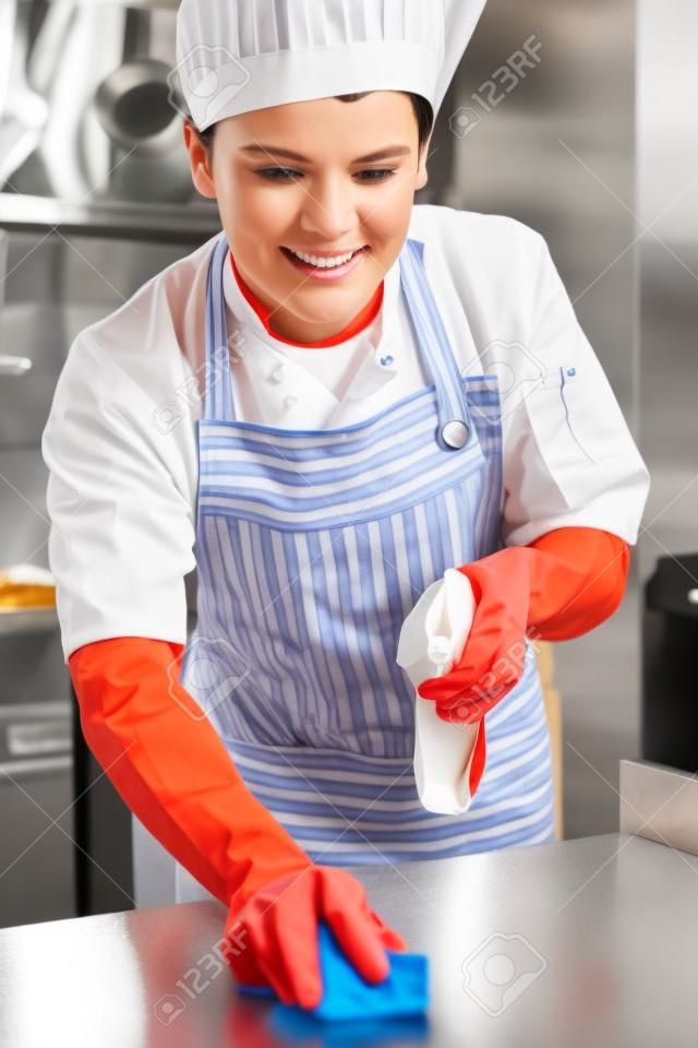 Worker In Restaurant Kitchen Cleaning Down After Service