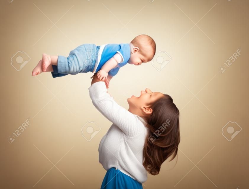 Happy mother playing with her baby son (isolated on white)