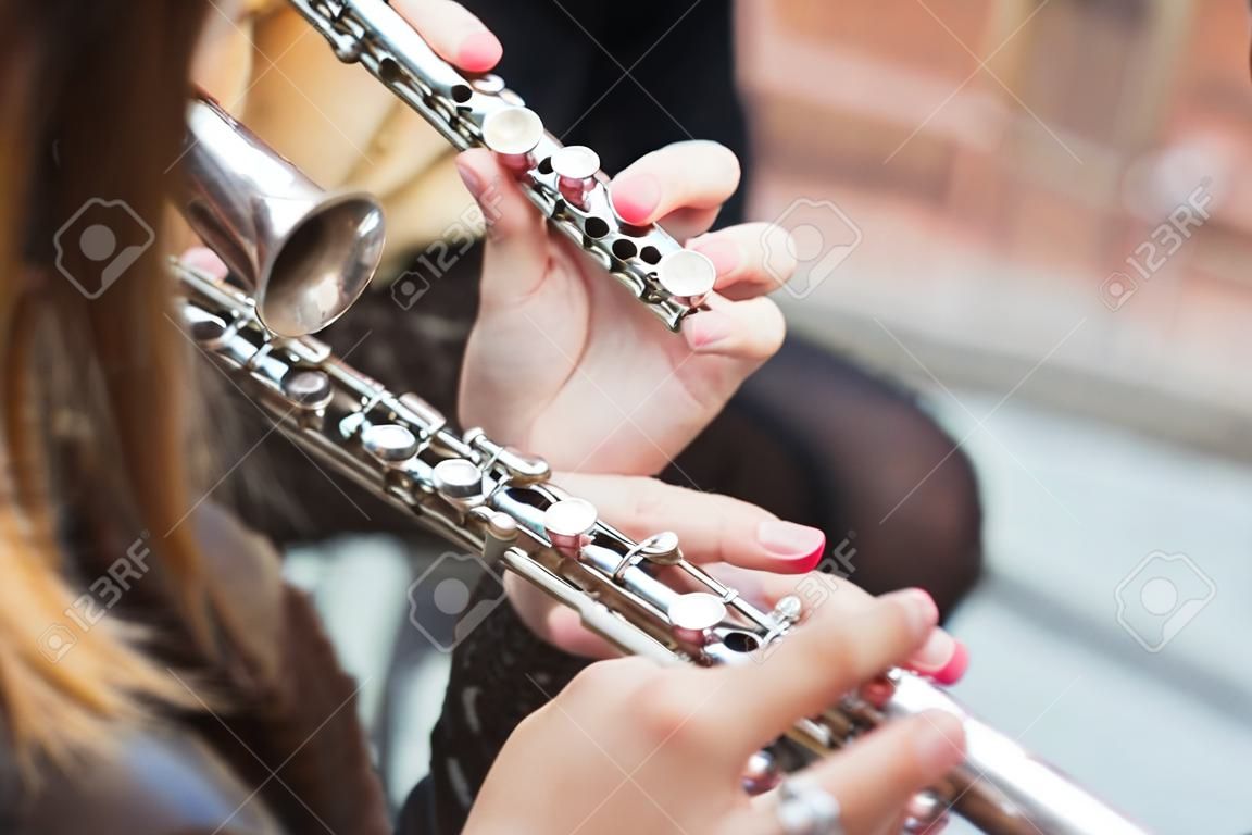 A girl plays a flute on a street concert