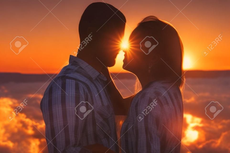 beautiful couple together watching a beautiful sunset.