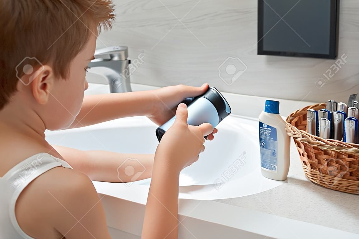 Little son opening deodorant in the bathroom