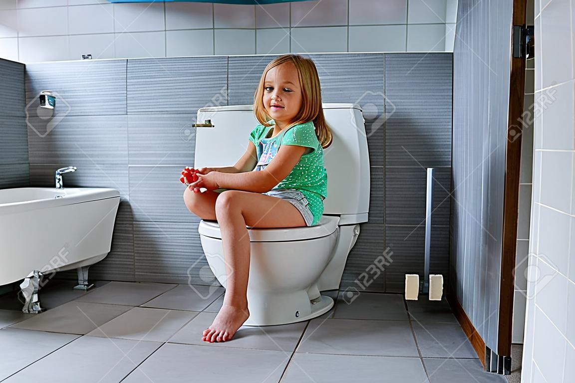 Cute little girl in toilet at home