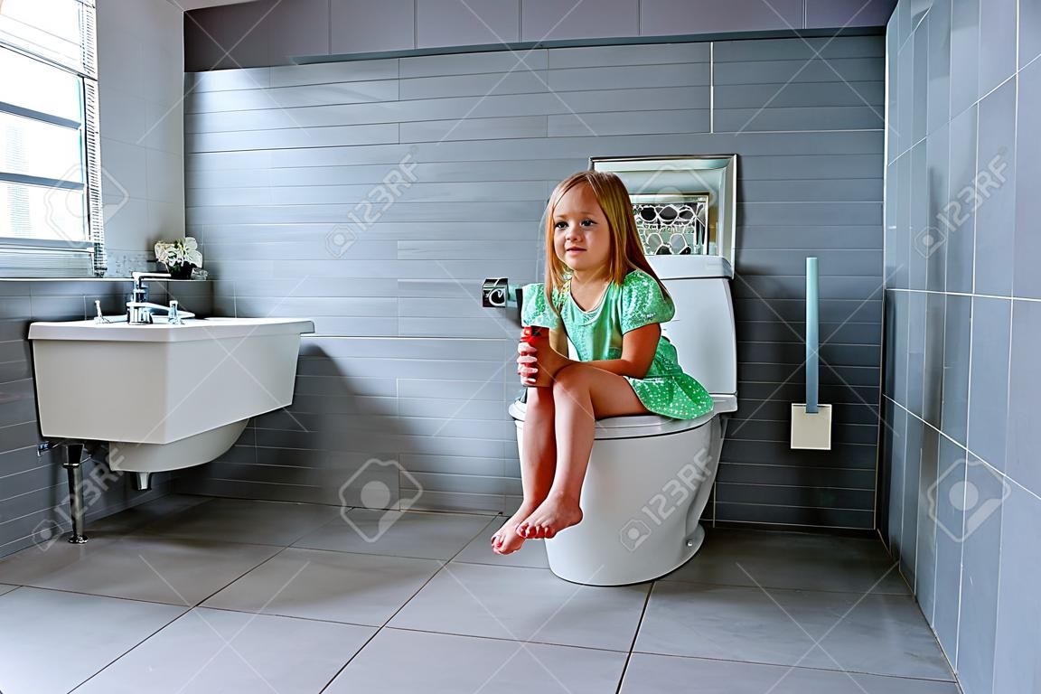 Cute little girl in toilet at home