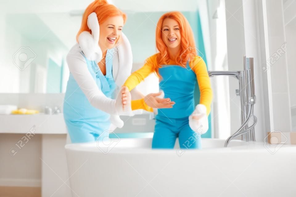 Cheerful mom near daughters in the bathroom