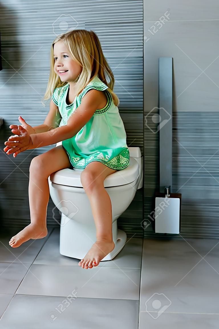 Happy young girl in toilet at bathroom