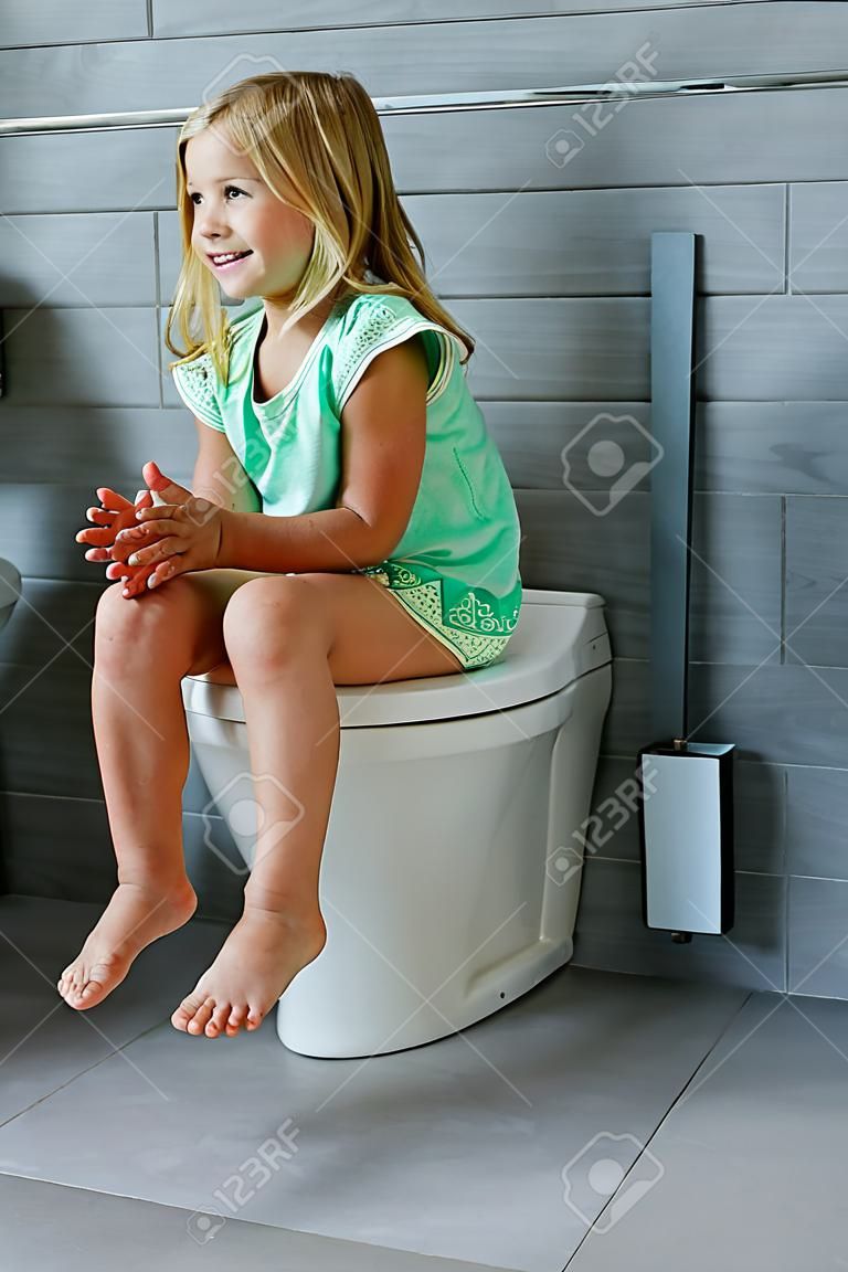 Happy young girl in toilet at bathroom