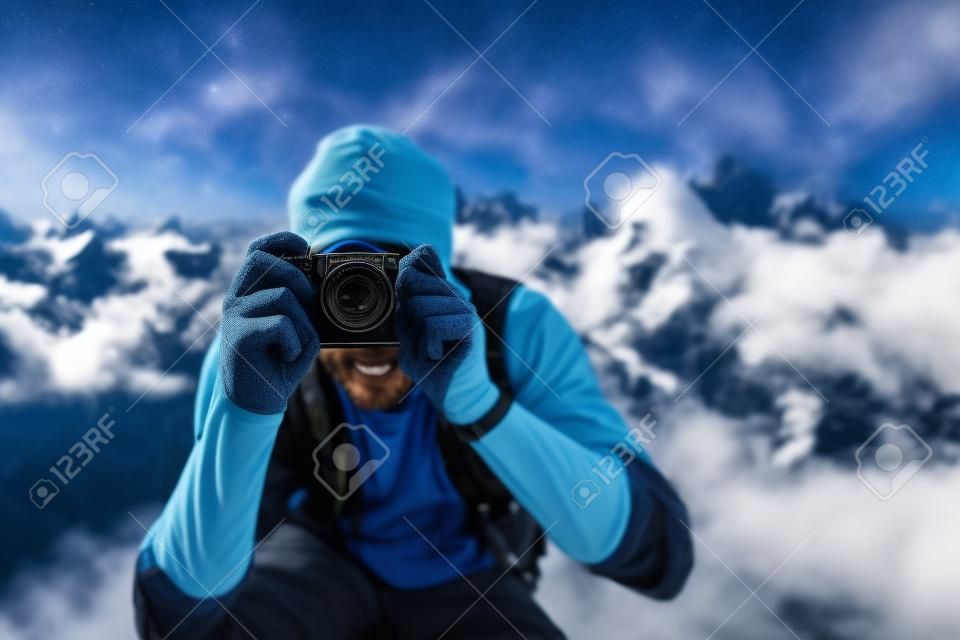 Traveler man taking photo on mountain hill