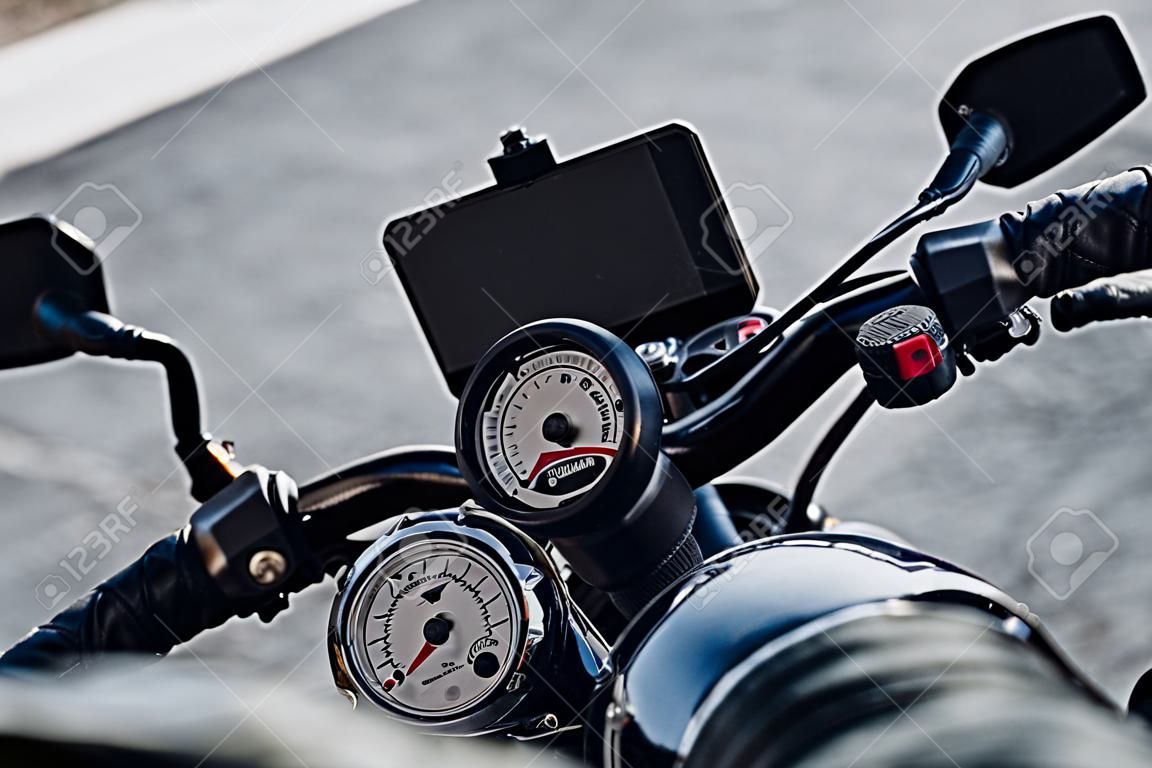 Cropped photo of motorcyclist sitting on classical motorbike outside stock photo