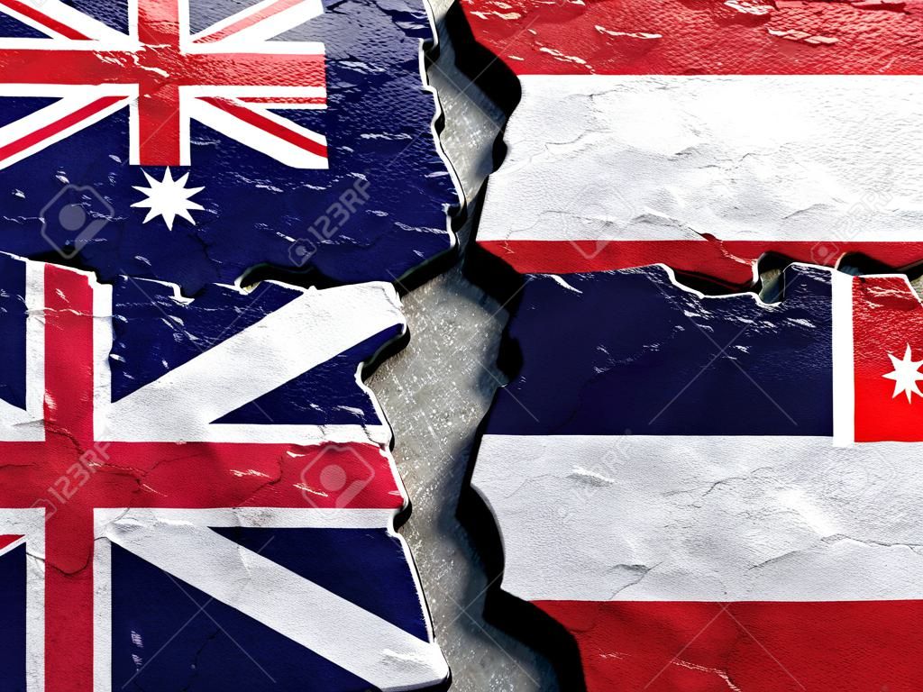 ひびの入ったコンクリートにタイとオーストラリアの旗（国際紛争の概念）