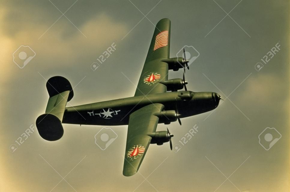 World War II era heavy American bomber on old scratched photo
