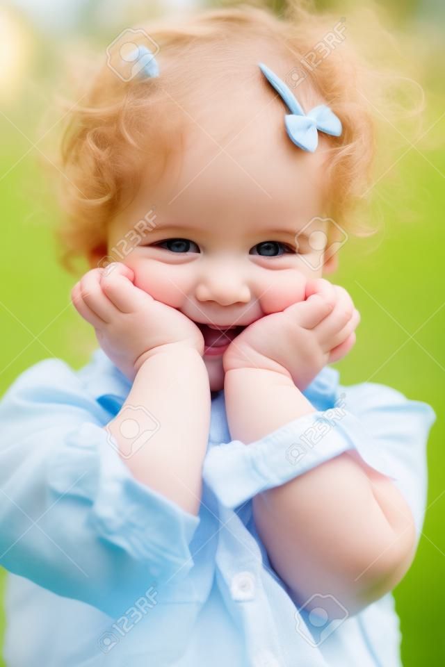 Retrato de feliz hijo de dos años al aire libre niña.