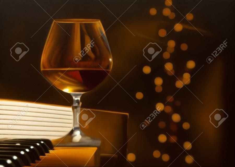  snifter with  brandy on a piano