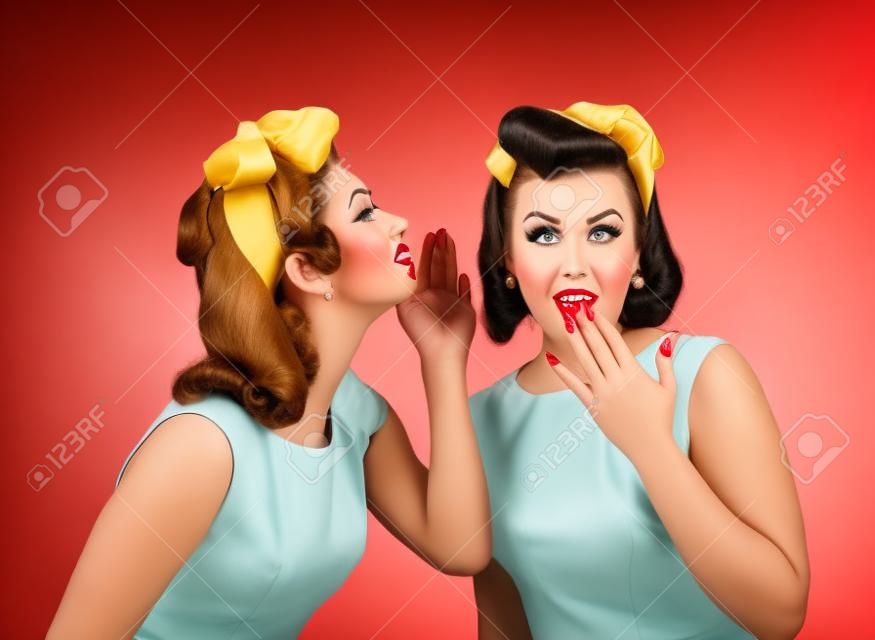 Beautiful women talking .Girls in pin up style with perfect hair and make up .Expressive facial expressions.