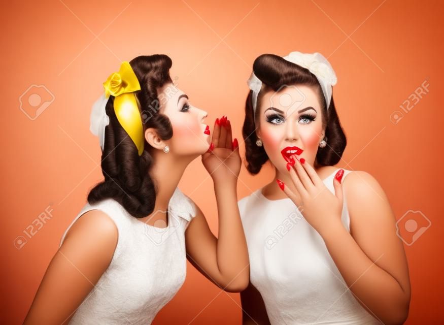 Beautiful women talking .Girls in pin up style with perfect hair and make up .Expressive facial expressions.