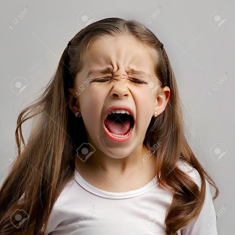 Studio portrait of a little girl yelling