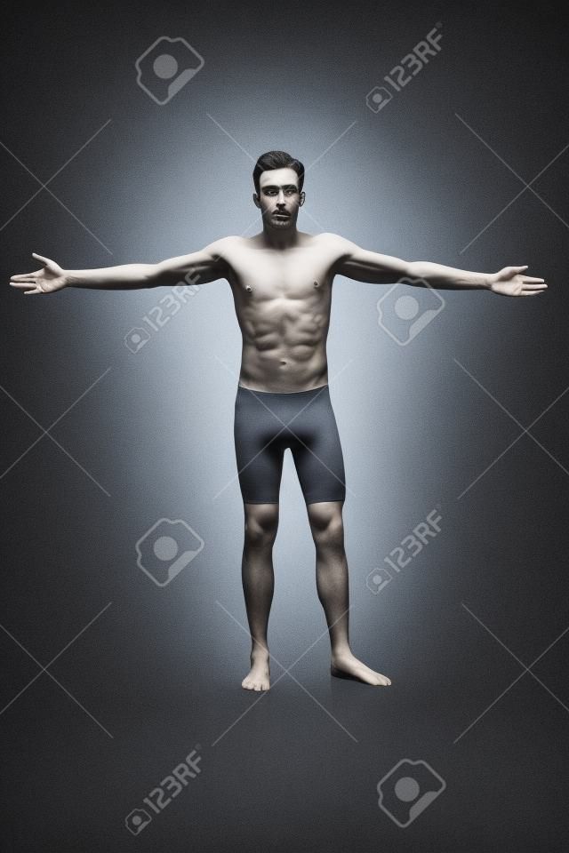 Shirtless man in tights with his arms outstretched