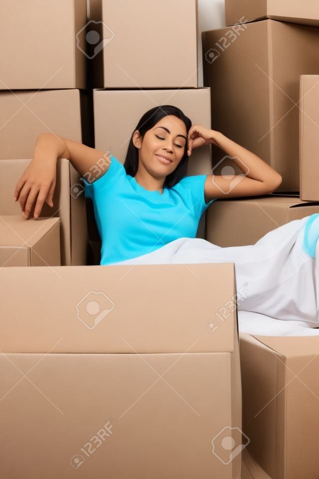 Woman sleeping with cardboard boxes around her