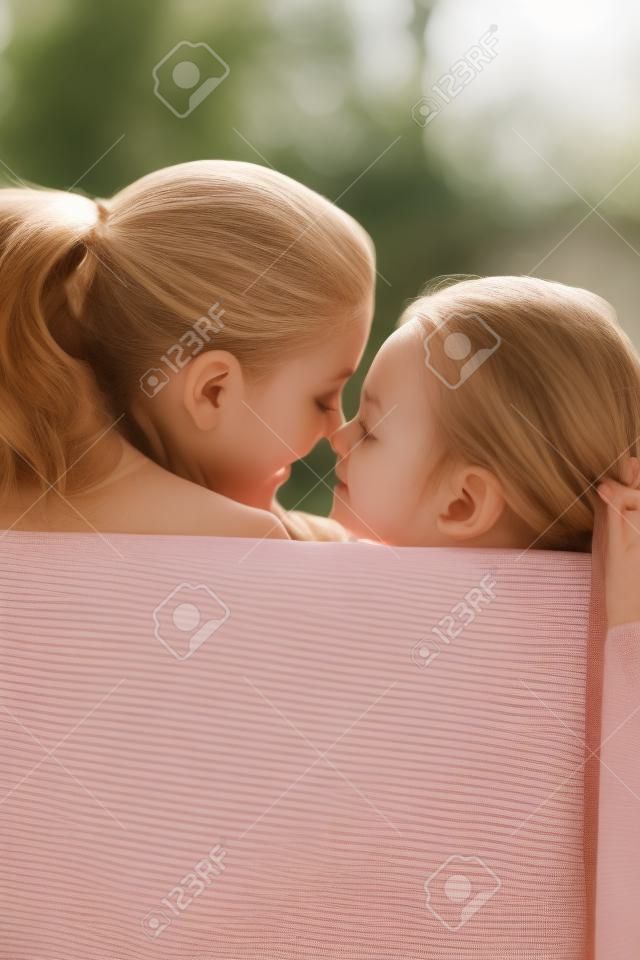 Woman and girl rubbing nose