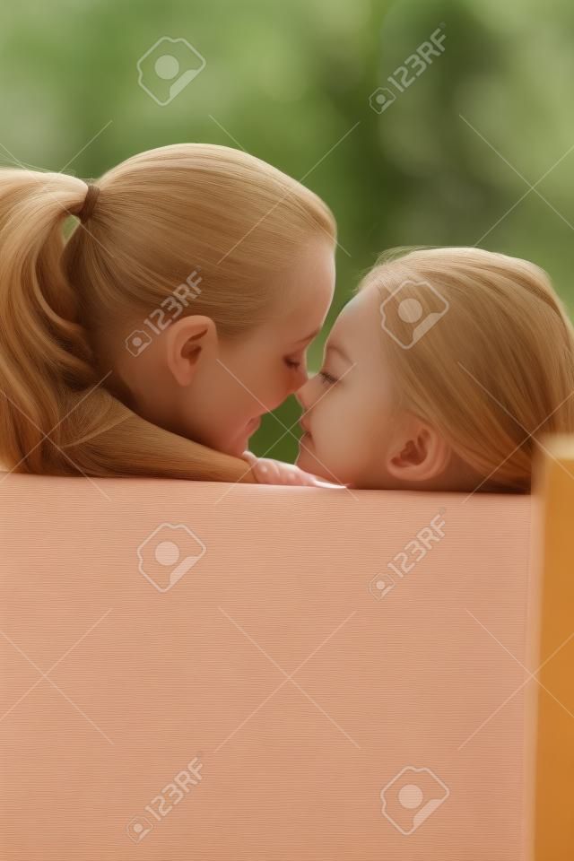 Woman and girl rubbing nose