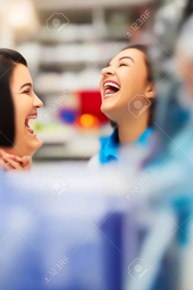 Women laughing together in store