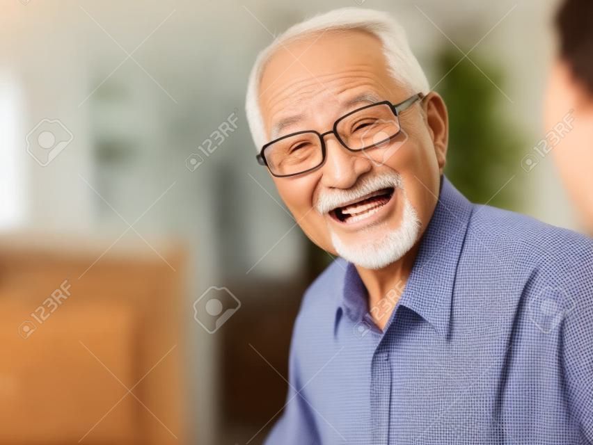 An old man talking animatedly at a family event